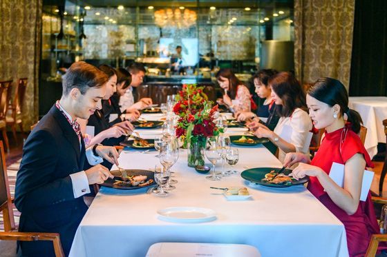 Guests at a formal seafood dinner during a table manners event