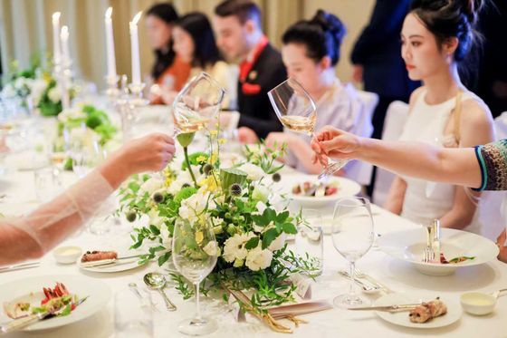 Guests at a social etiquette dinner with floral table settings